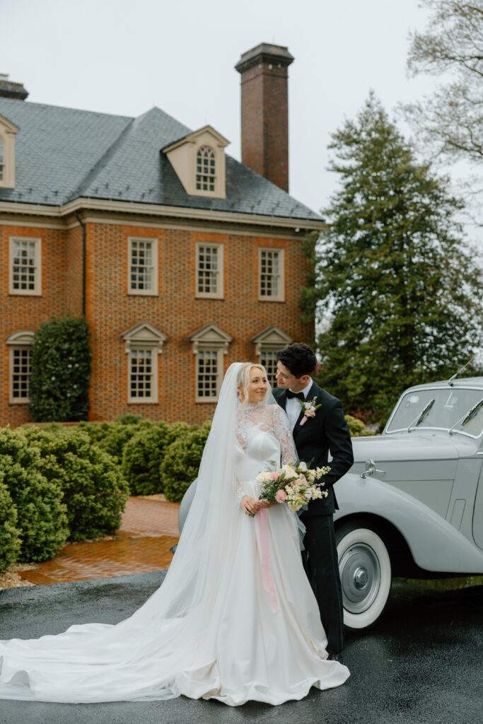 bride and groom with vintage car at estate at river run