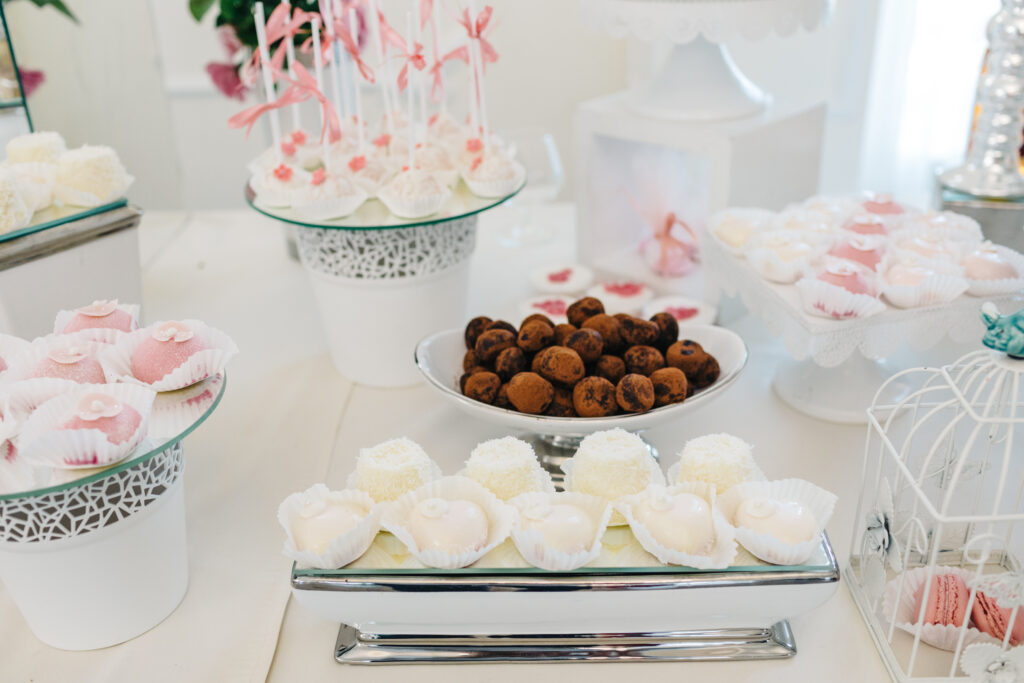 wedding dessert display table with chocolates and cake pops