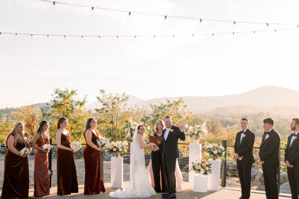 wedding officiant with bride groom and bridal party