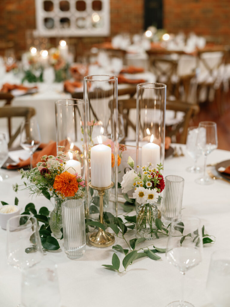 Reception table with candles and flowers Estate at River Run