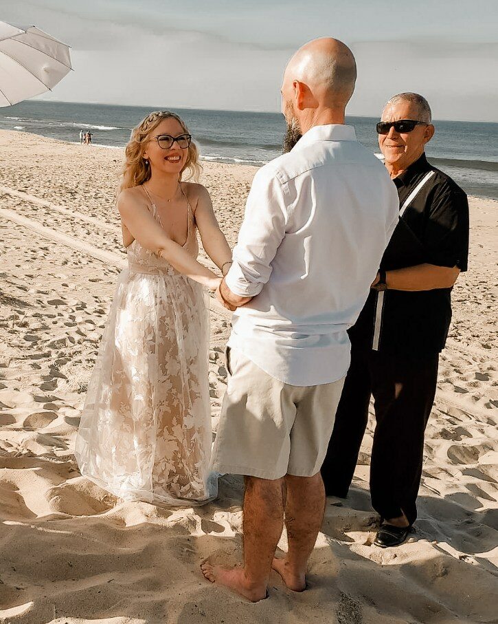bride and groom saying vows on the beach