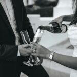 Couple pouring champagne into glasses