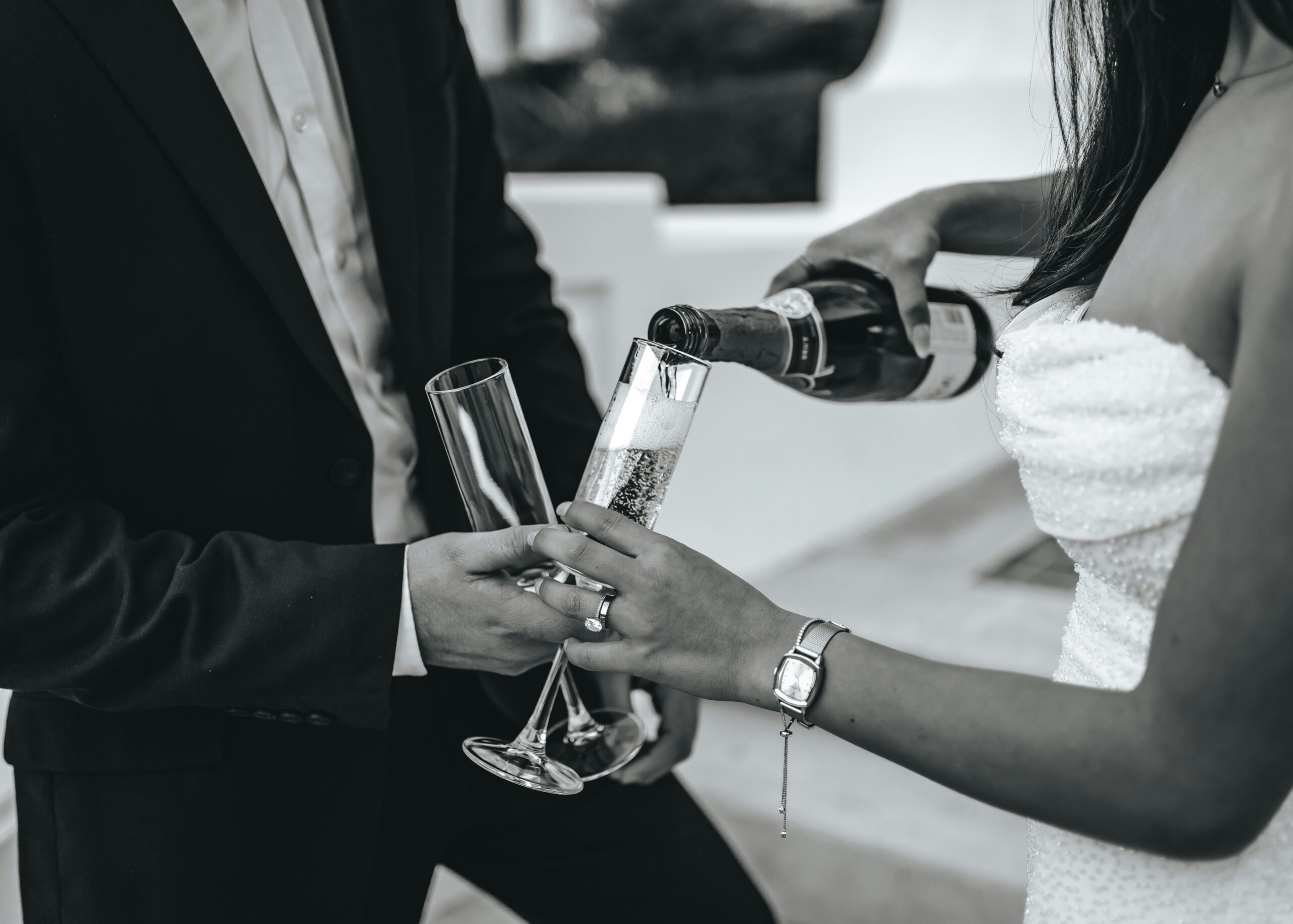 Couple pouring champagne into glasses