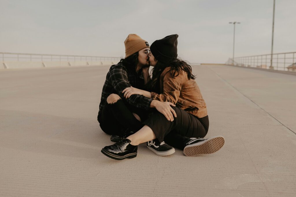 Couple sitting on ground kissing