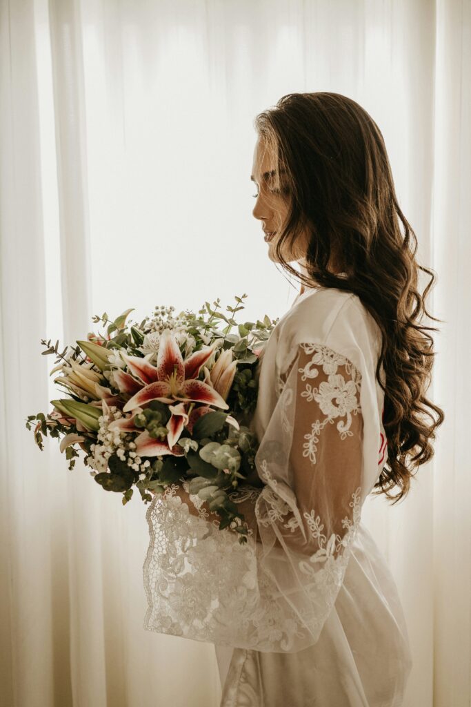 Bride getting ready holding bouquet