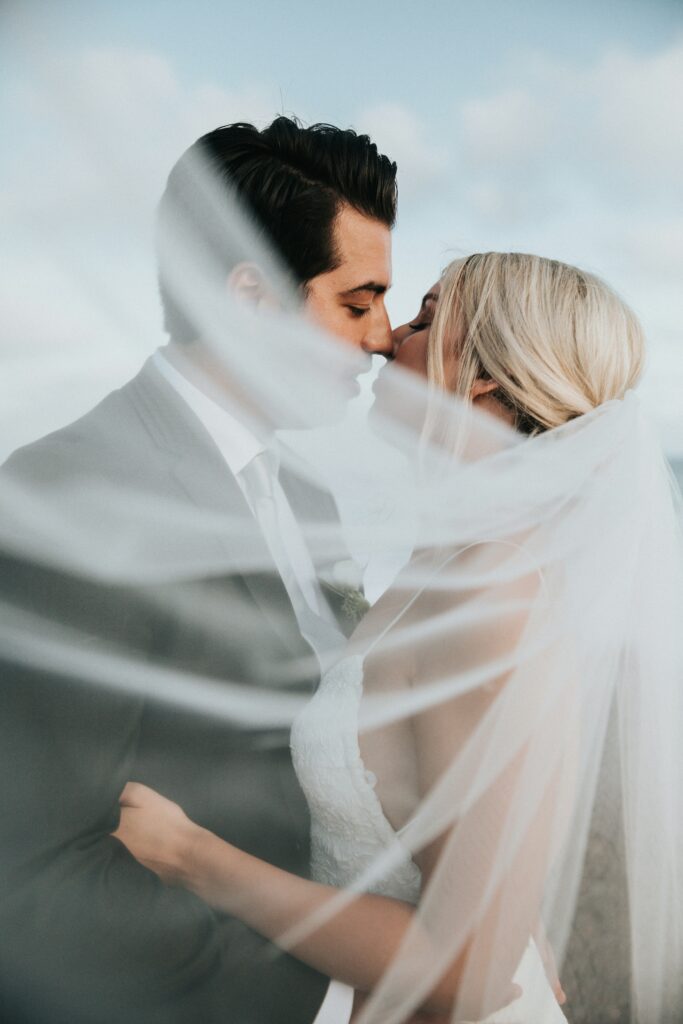 bride and groom with veil swooping