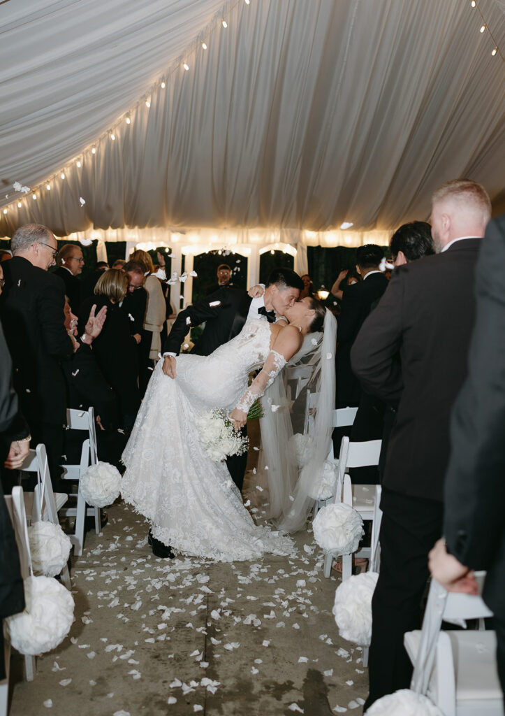 groom dipping bride first kiss