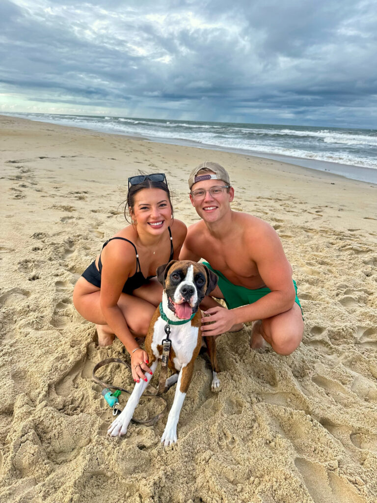 Couple with their dog on the beach