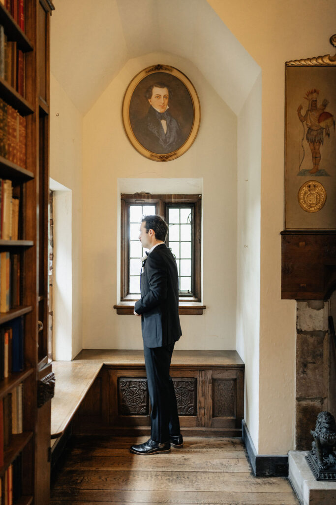 Groom looking out window