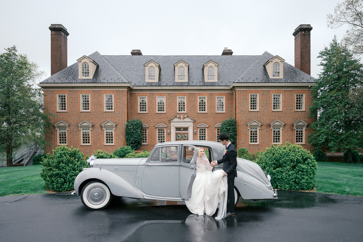 estate-at-river-run-wedding-kaytlyn-rei bride and groom in front of mansion with vintage car