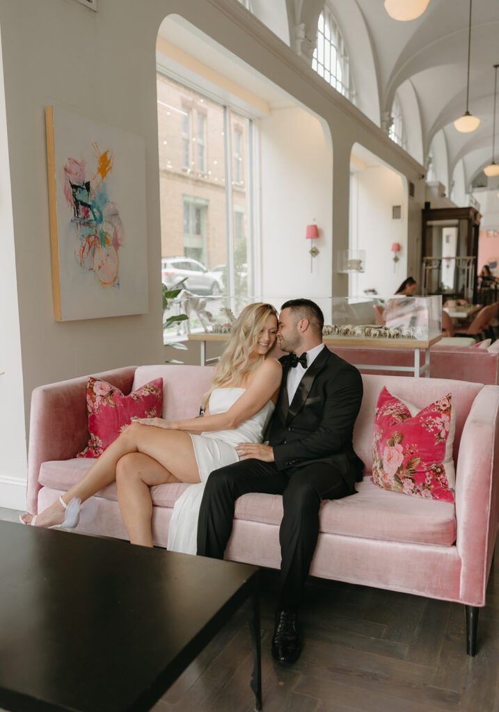 engaged couple on pink couch