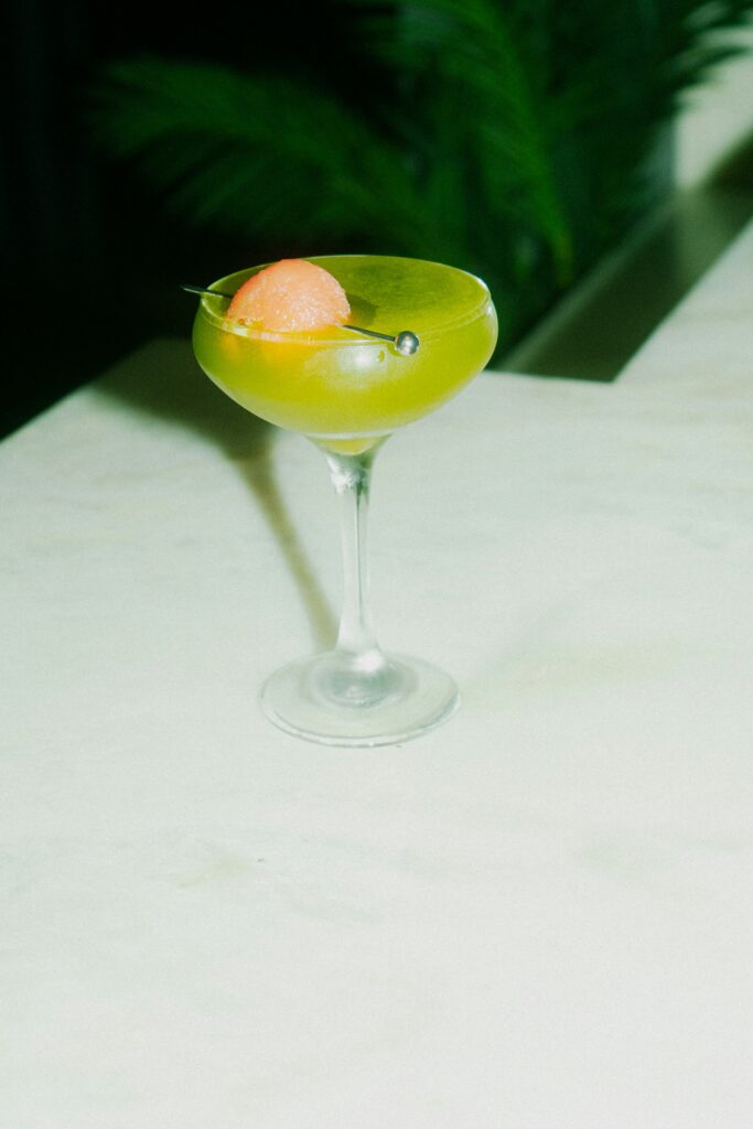 Lime green cocktail in martini glass