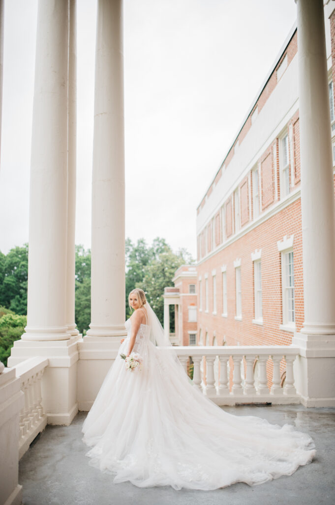Bride standing on balcony at the Inn at Blackstone