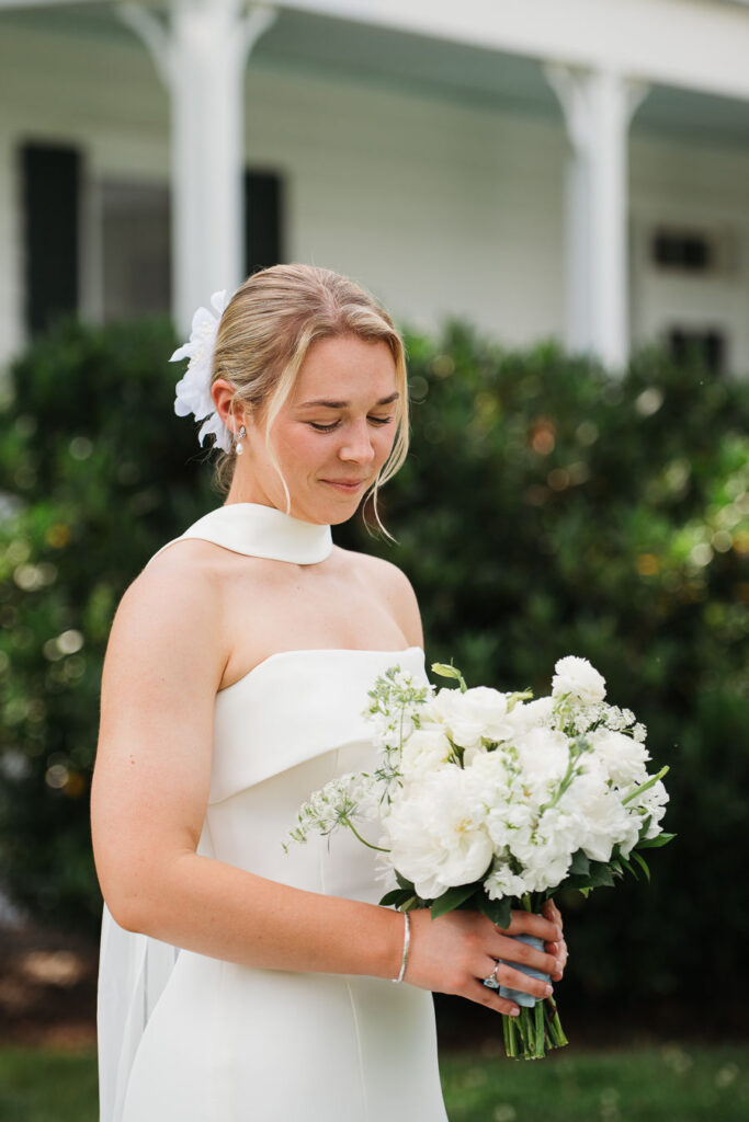 Bride looking down at flowers